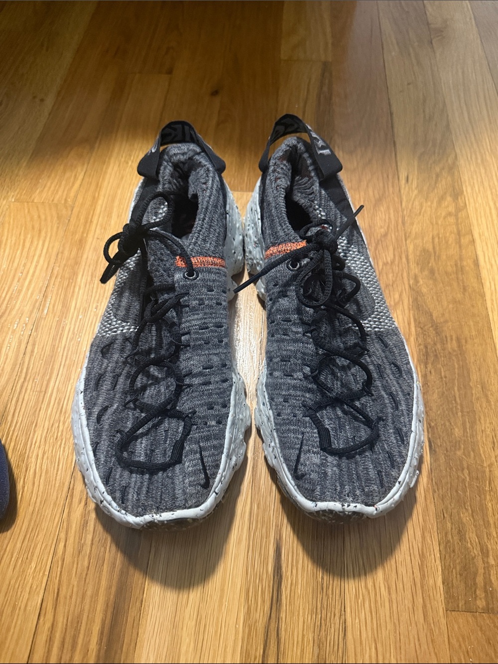 Nike woman’s  Gray Knit Athletic Shoes with Black Laces and Orange Accent